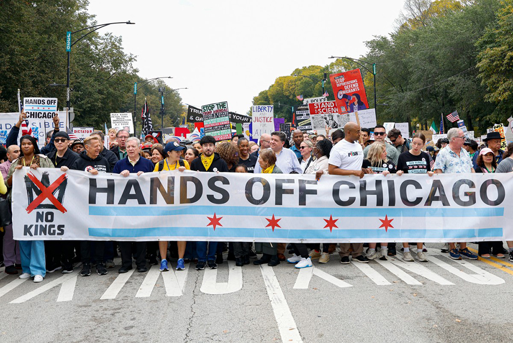 Illinois Governor JB Pritzker (C) attends a rally during the "No Kings" national day of protest in Chicago on October 18, 2025. From New York to San Francisco, millions of Americans are expected to hit the streets to voice their anger over President Donald Trump's policies at nationwide "No Kings" protests.