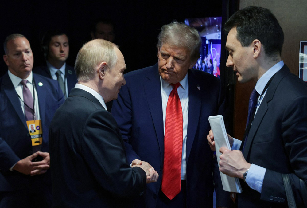US President Donald Trump (C) and Russian President Vladimir Putin (L) shake hands after delivering a joint press conference following a US-Russia summit on Ukraine at Joint Base Elmendorf-Richardson in Anchorage, Alaska, on August 15, 2025. (AFP)