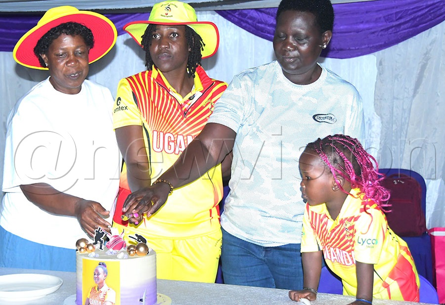 Noome Kayodo Bagenda (middle) cutting a cake with her relatives at her testimonial. Photo:Silvano Kibuuka
