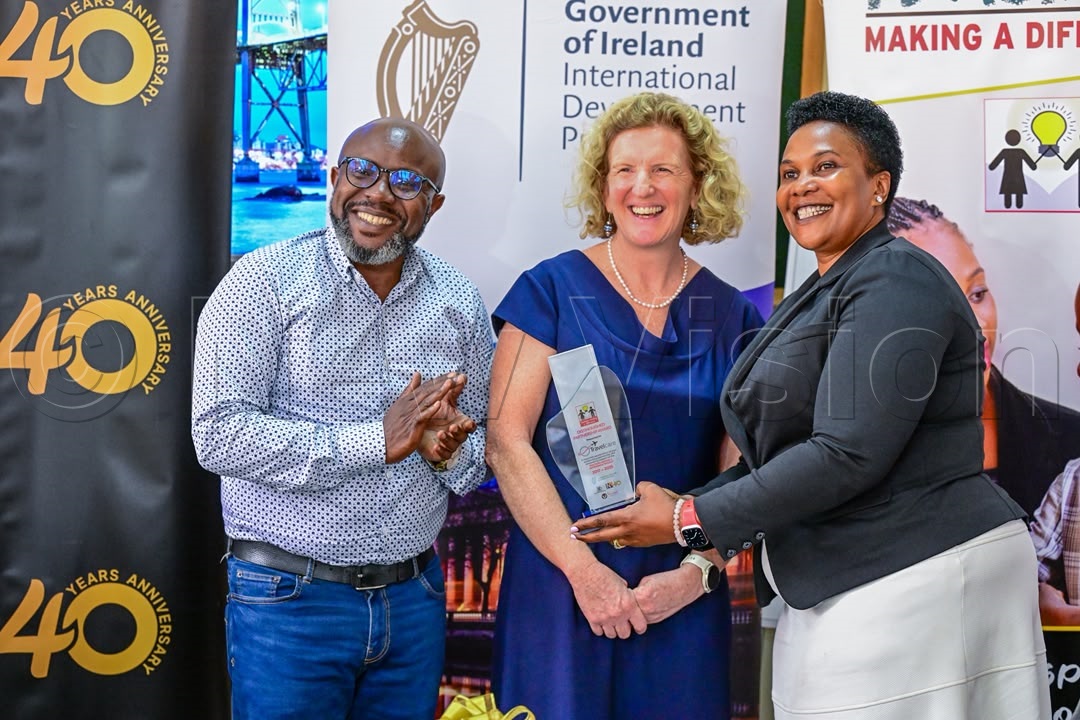 L–R: Vision Group CEO Don Wanyama and Ireland's Ambassador to Uganda, Mags Gaynor, present a gift to Lydia Bakashakaruhanga, General Manager of Travel Care. (Credit: Miriam Namutebi)