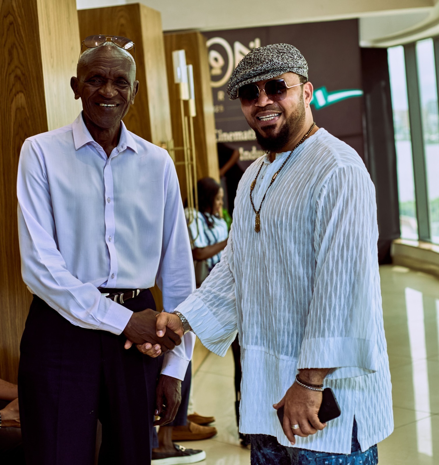Seasoned actor and iKON lifetime Achievement Award winner Michael Wawuyo Sr. (L) shakes hands with actor and producer Ramsey Nouah during iKON Activate in Nigeria last year. File Photo 