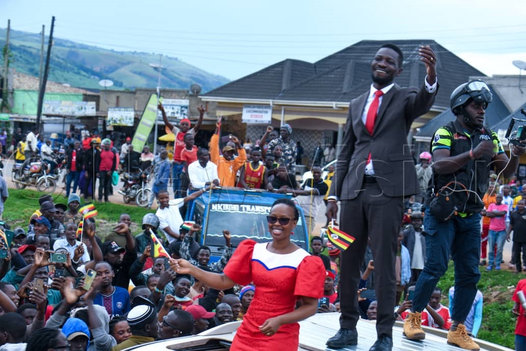 Kyagulanyi and wife Barbie waving to supporters.