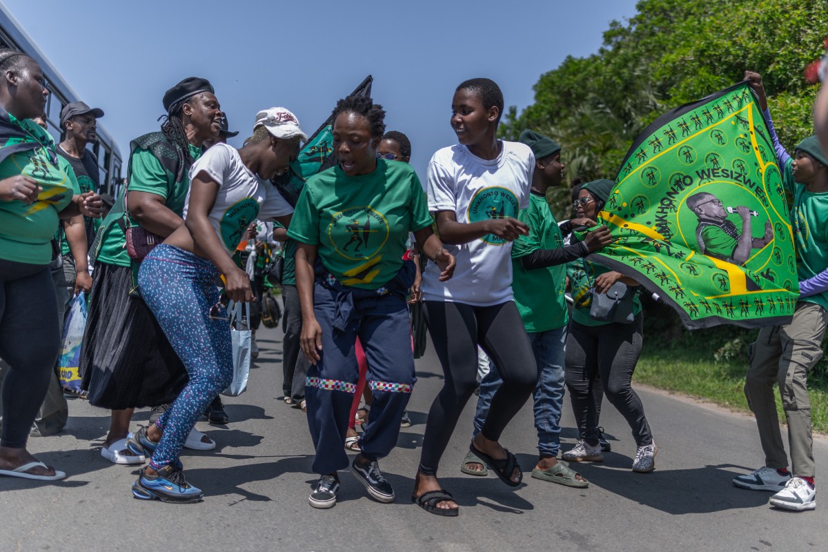 Supporters of the UmKhonto we Sizwe Party (MKP) sing and chant slogans during an election campaign mini rally in Umgababa, south of Durban on October 18, 2026, ahead of the country’s upcoming municipal elections. (Credit: AFP)