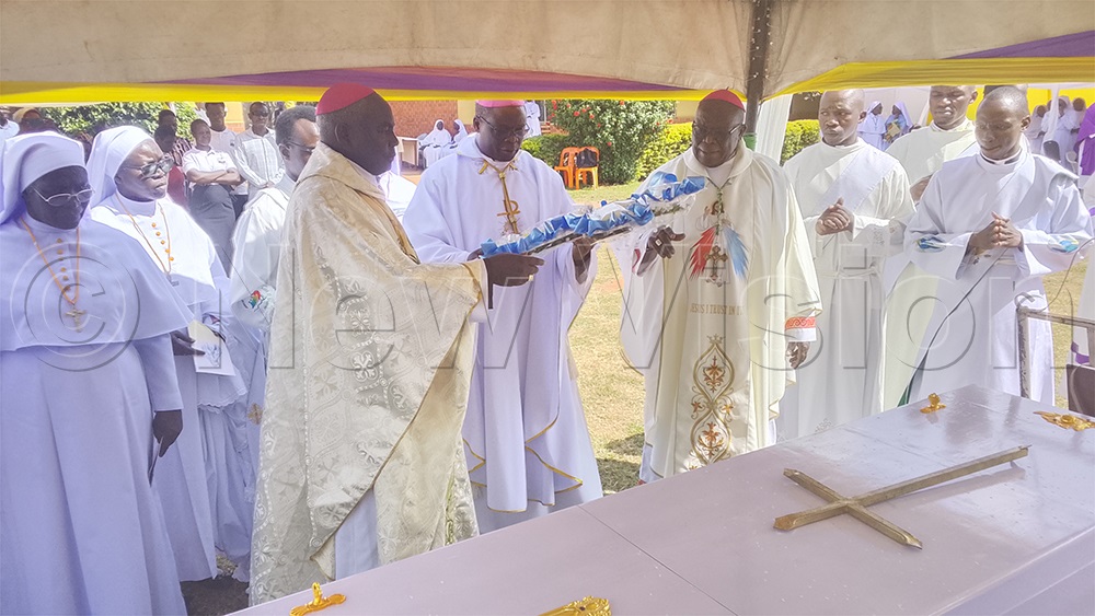 Bishops Wanok, Odama and Eibu laying a wreath on the casket of Sr Driciru. (Credit: Joseph Ekol)