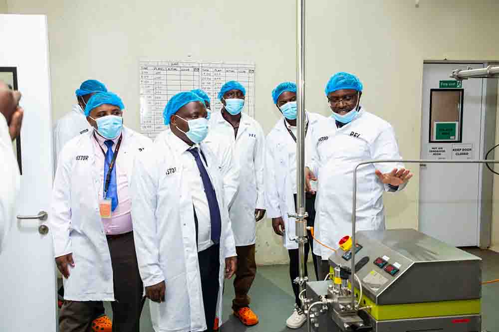 State Minister for Industry David Bahati (center) during a tour of the facility.