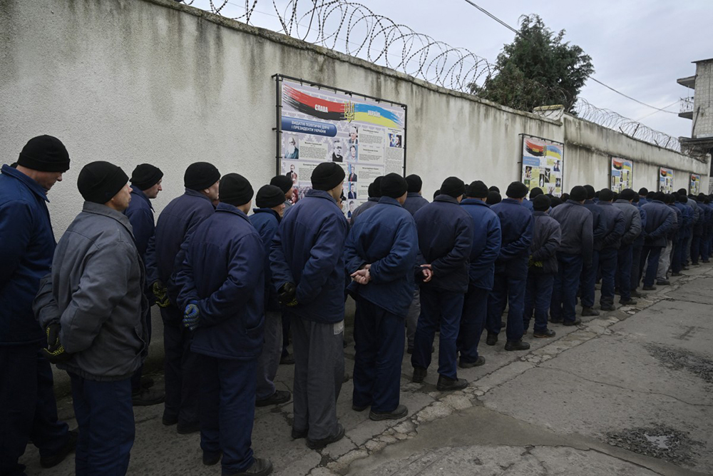 Russian prisoners of war stand at a detention center for Russian POWs in western Ukraine on November 26, 2025, amid the Russian invasion of Ukraine. (Photo by Genya SAVILOV / AFP)