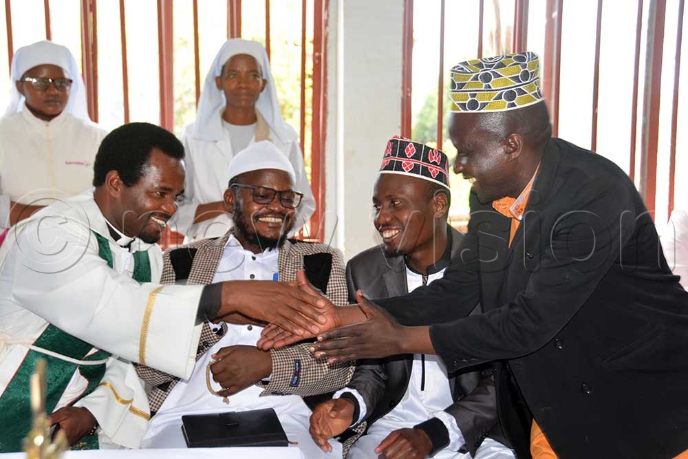 Rev. Godwin Akamwesiga (L) as Muslim clerics (L-R) Sheik Abdrrahman Lulue, Sheik Abubakar Mubeedo,  and Imam Hamza Chuka during prayer day at Avance International University. (Credit: Francis Emorut)