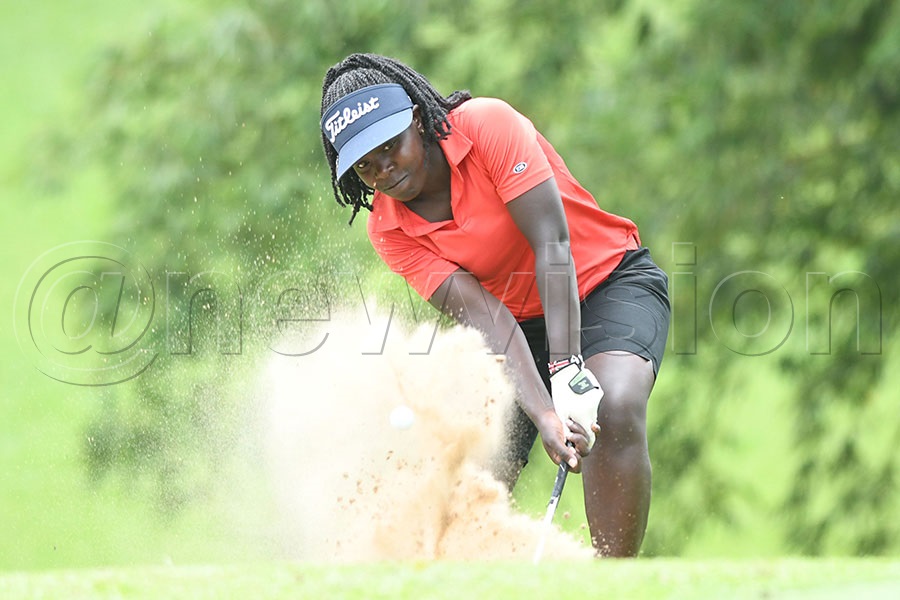Kenyan Ashley Awour chips from a bunker on hole-9. Photo by Michael Nsubuga