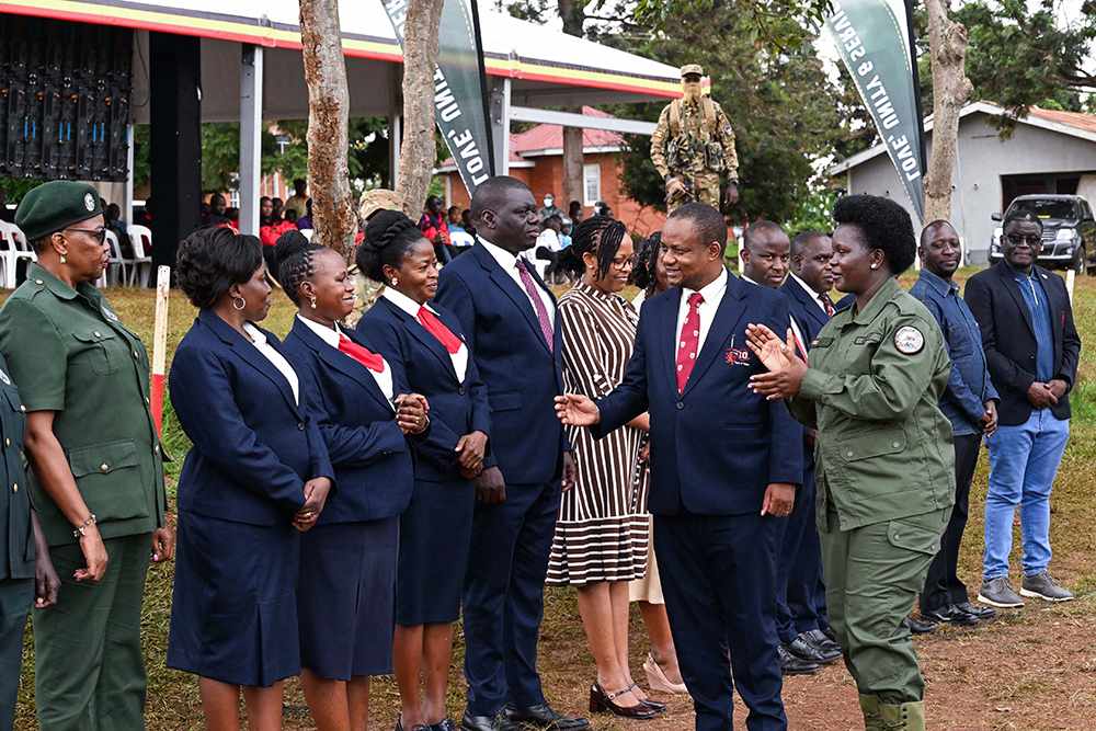 Head teacher of Kings College Budo (2nd R) introduces his teachers to Commissioner Patriotism Helen Seku during the passout of patriotism students at Buddo on Saturday. (PPU Photo)