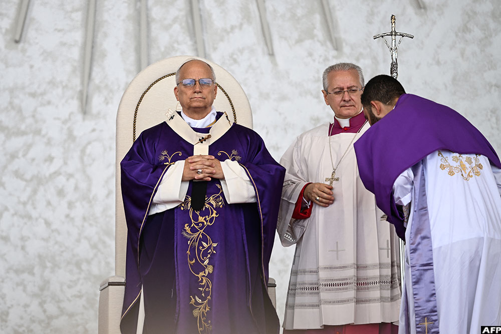 Pope Leo XIV (L) leads a mass at Beirut's waterfront on December 2, 2025