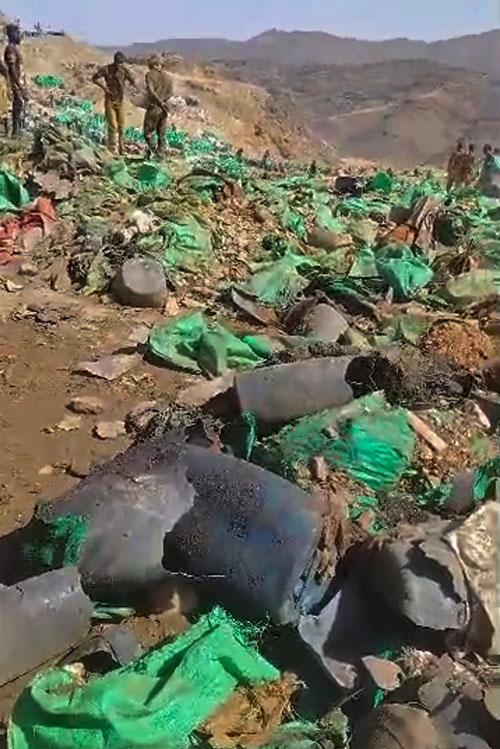 This screen grab made from the UGC footage obtained on October 12, 2026 shows people inspecting the site of an airstrike in the mining area of Jabal al-Uqaydat, in Sudan