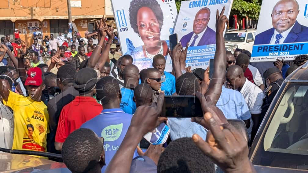 FDC supporters waving Nandala Mafabi's campaign posters and the Woman MP Deborah Akiteng. (Photo by Isaac Nuwagaba)