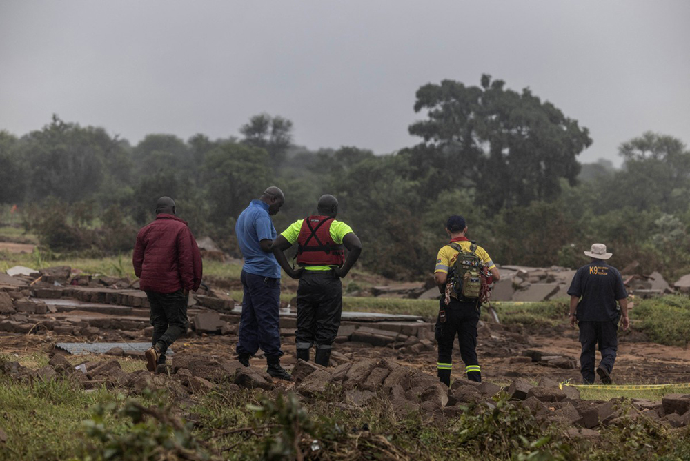 Members of a search and rescue team stand between debris following floods in Mbaula village, 50 km from Giyani on January 17, 2026 following heavy rains over much of the Limpopo Province, South Africa.