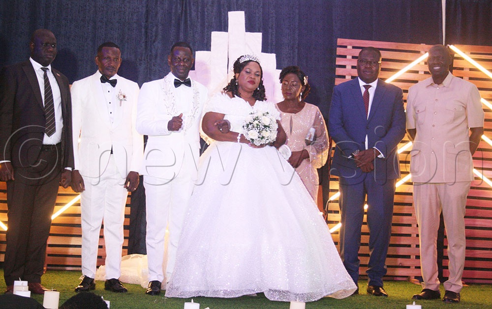 MP Apollo Yeri Ofwono and defence minister Jacob Markson Oboth with the Kawesas after the renewed vows. (Credit: Maureen Nakatudde)