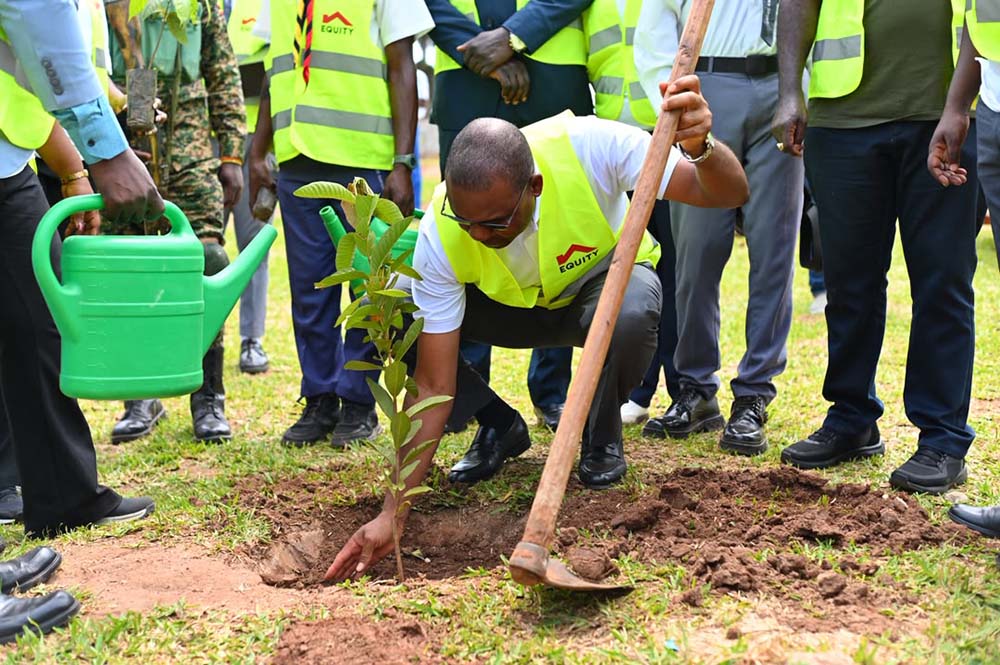 Gift Soko, the Managing Director of Equity Bank Uganda planting a tree during the launch of the Equi Green Schools Programme at Nakanyonyi SS.