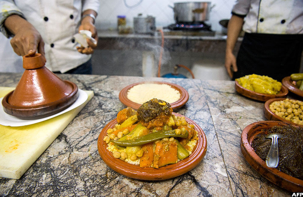 A Moroccan chef prepares a traditional couscous dish in a restaurant in Rabat