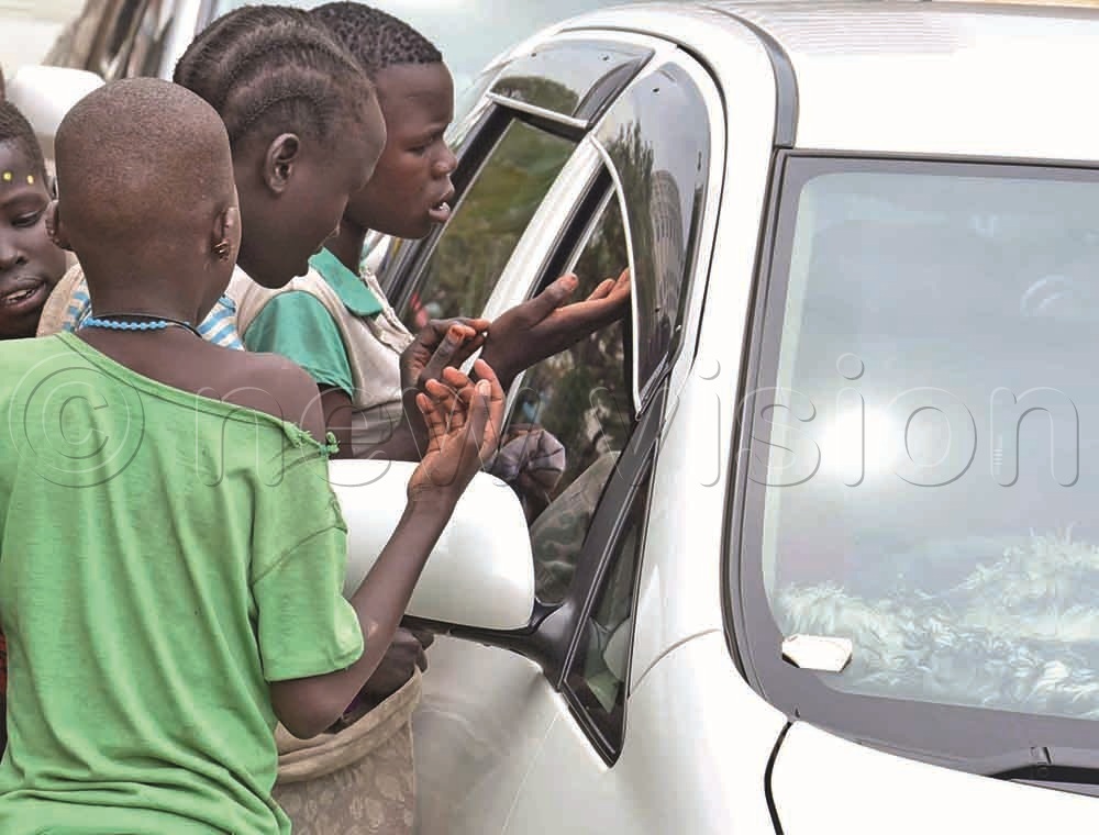 Vulnerable children from Karamoja begging for money from car drivers at a traffic light junction in Kampala, along Entebbe Road. It is alleged that the children are trafficked from Karamoja and used to beg as a business.