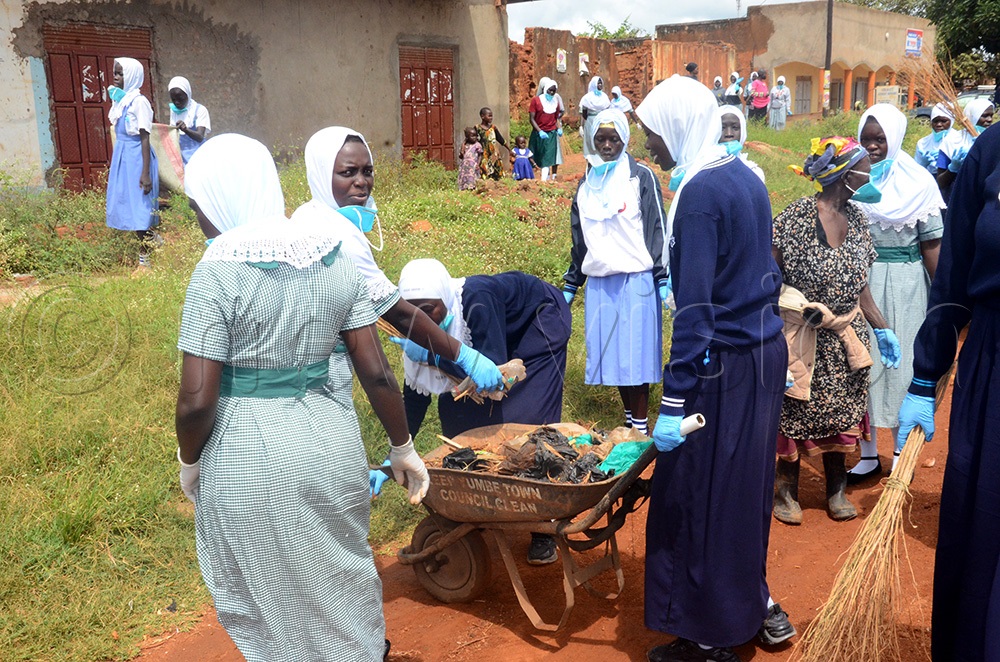 Students in a massive cleaning exercise in Yumbe town ahead of presidential flag-bearer Yoweri Museveni campaign in the area. (Photo by Adam Gule)