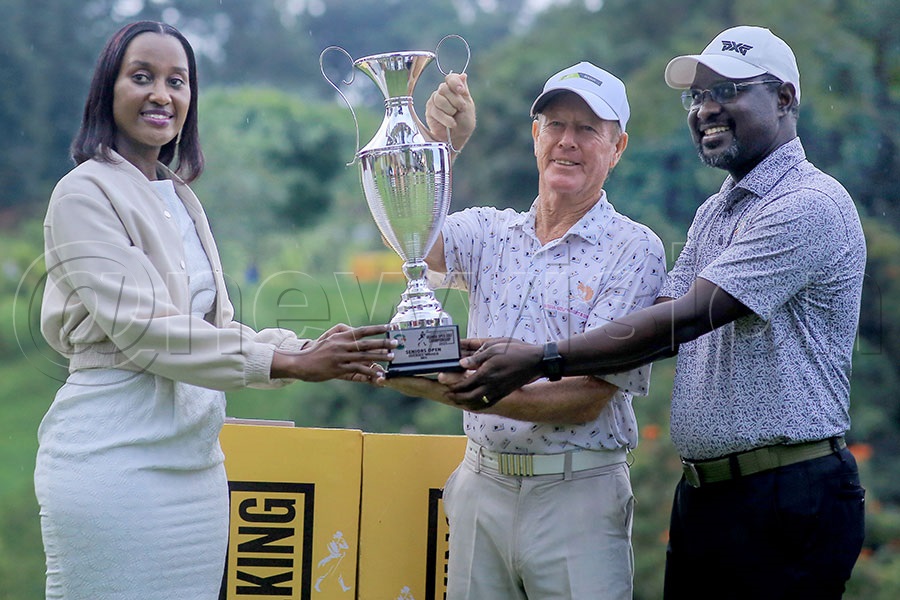 David Plenderleith (centre) is crowned by Johnnie Walker's Christine Kyokunda (left) and UGU president Jackson Were after the Johnnie Walker Uganda Open Golf Championship at the Lugazi Hills Golf and Country Club. Photo by Michael Nsubuga