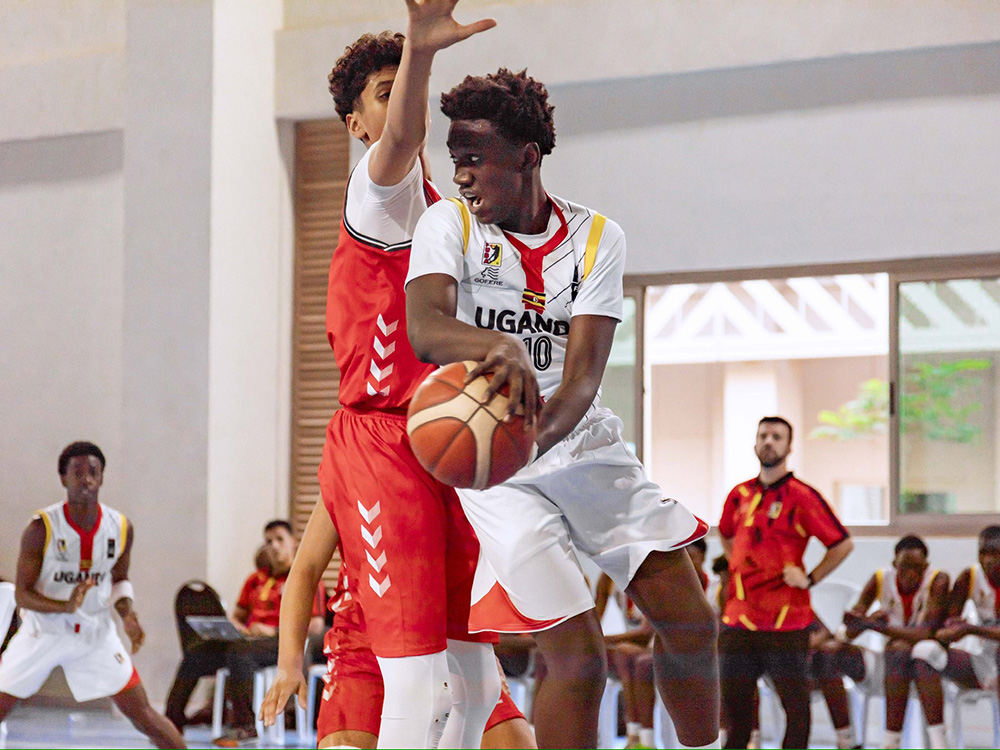 Uganda's Lucas Ssenyonjo evades the attentions of a Tunisian defender during Saturday's classification game in Kigali. (Courtesy Photo/FERWABA)