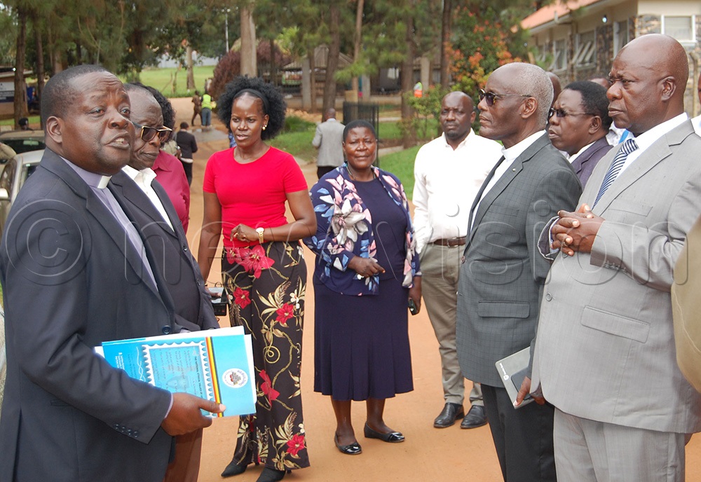 The Archdeacon of Namugongo, Venerable Michael Wasswa Ssentamu (left) gives an explanation to the Chairman of the Uganda Martyrs Day (2026) National Organising Committee (NOC), Hon. Dunstan Balaba (right) and other members of the committee. (Photo by Mathias Mazinga)