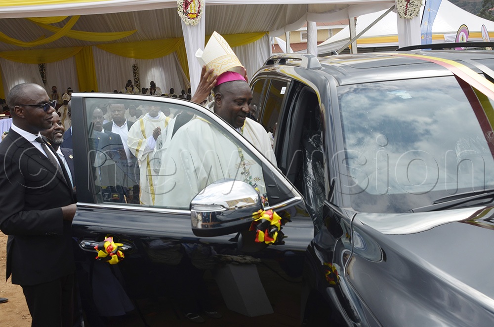 The newly ordained Bishop of Kabale Catholic Diocese, Bonaventure Bosco Katusiime Gubazire, getting into the car that was gifted to him by President Yoweri Museveni. (Photo by Juliet Anna Lukwago)