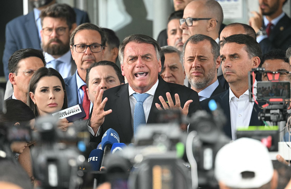  Former Brazil's President Jair Bolsonaro (C) speaks to the media after leaving the Senate building in Brasilia on Wednesday. Brazil's Supreme Court ordered far-right ex-president Jair Bolsonaro to stand trial on charges of plotting a coup after failing to win re-election in 2022. (AFP Photo)