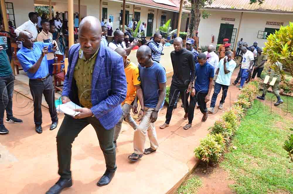 The suspects being led to court where they were charged  three charges: murder, kidnapping, and aggravated robbery. (Credit: Stuart Yiga)