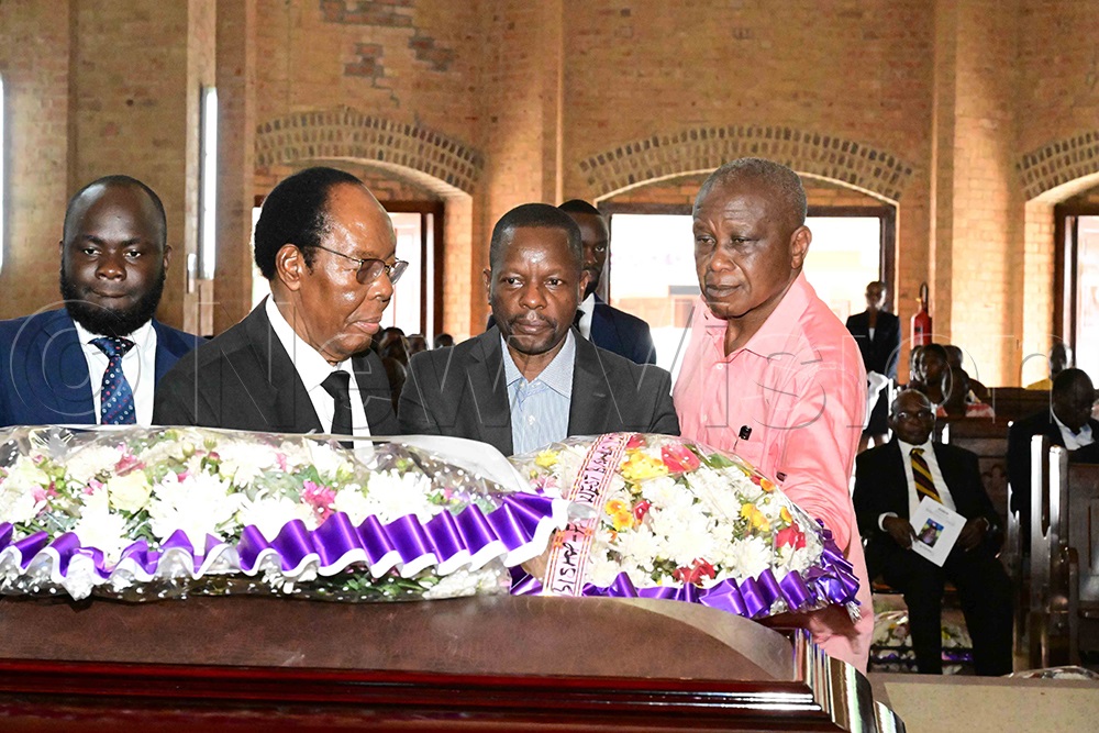 Lawyer John Katende (second left) was among the mourners who laid wreaths on the casket of the late Bishop Christopher Ssenyonjo during the funeral service. (Credit: Eddie Ssejjoba)