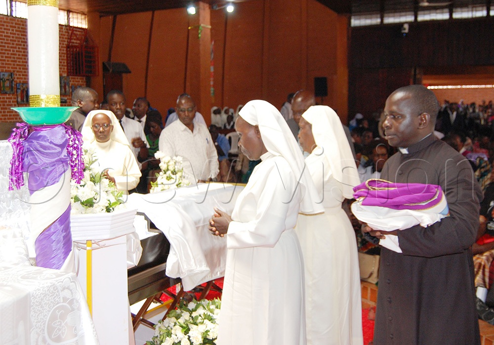 Grief-stricken Catholic nuns, priests and lay Christians viewing the body of Fr. James Kabuye ahead of the requiem mass. (Photo by Mathias Mazinga)