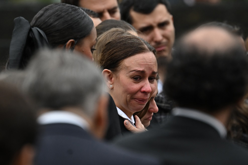 Maria Claudia Tarazona, widow of slain presidential hopeful and senator Miguel Uribe, mourns during his burial at the Central Cemetery in Bogota on August 13, 2025. (AFP)