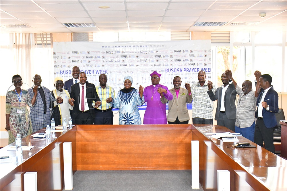 The Third Deputy Prime Minister, Rukia Nakadama (C), in a group photo with local government and religious leaders and BCD officials after launching the preparations for organising the Busoga Prayer Week at Civil Service College of Uganda in Jinja City.