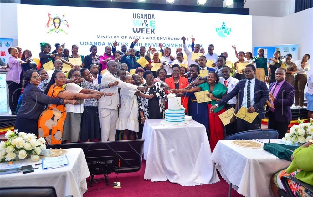 Dr Alfred Okidi, Dr Mary Wenene, Deputy Head of Public Service, Justice Stella Alibateese cut a cake as mentees look on during the graduation ceremony of the fifth cycle of the Water Resources Institute (WRI) mentorship programme at the Water ministry headquarters in Luzira on March 26, 2026. 