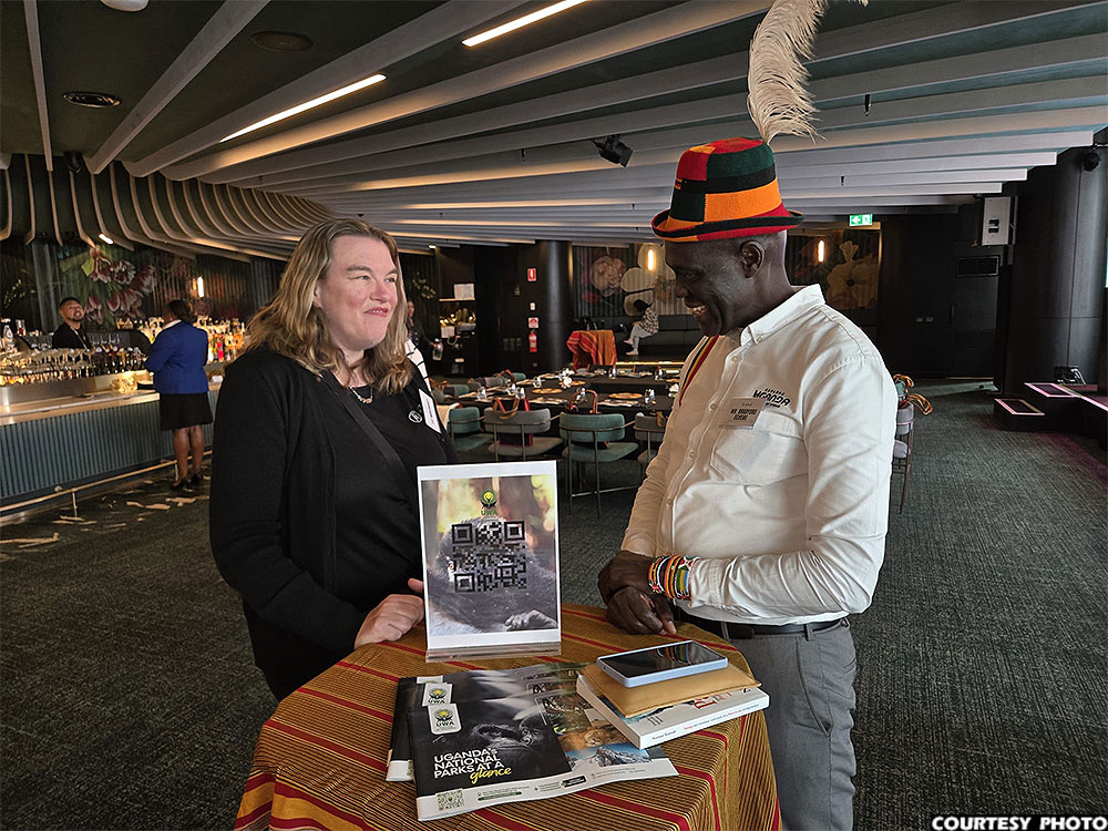 UTB deputy CEO Bradford Ochieng (R) interacting with a guest