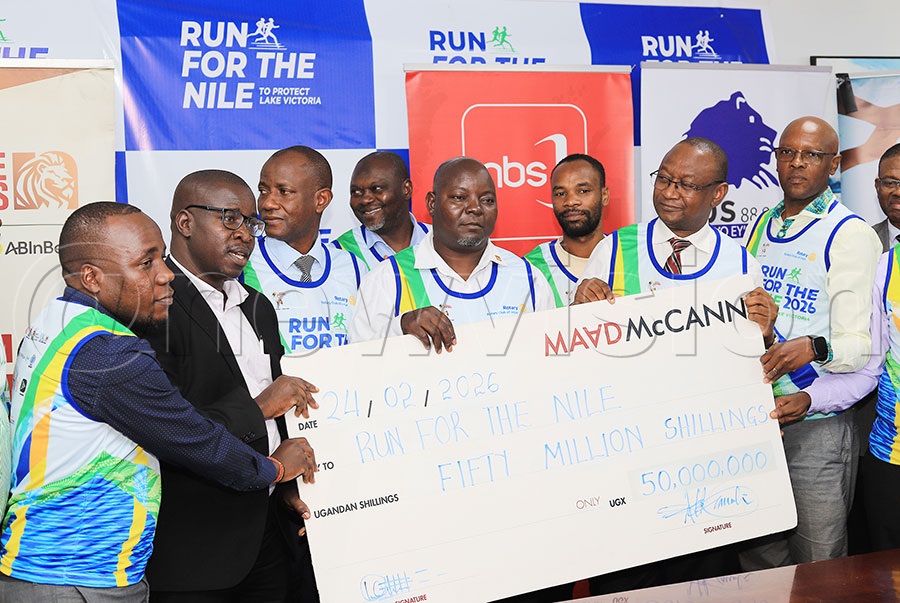 The president of Rotary Club of Jinja  Tomson Ofwono (C), Rotarian Geoffrey Kitakule (2nd right), Rotarian David Serwawudde (R) receive a sh50m dummy cheque from Maad Mc Cann officials at the launch of the Run for the Nile at Platinum Credit offices in Kampala. PHOTO: Johnson Were
