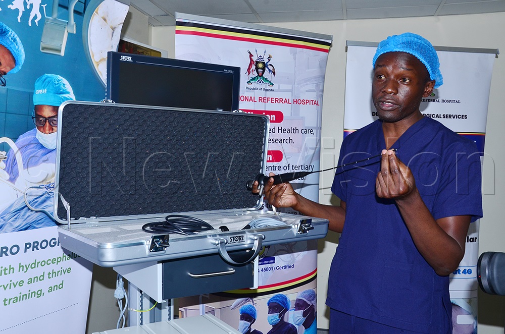 Dr Paul Okiror, Neurosurgeon, Mulago, explaining how the equipment works. (Credit: Agnes Kyotalengerire)