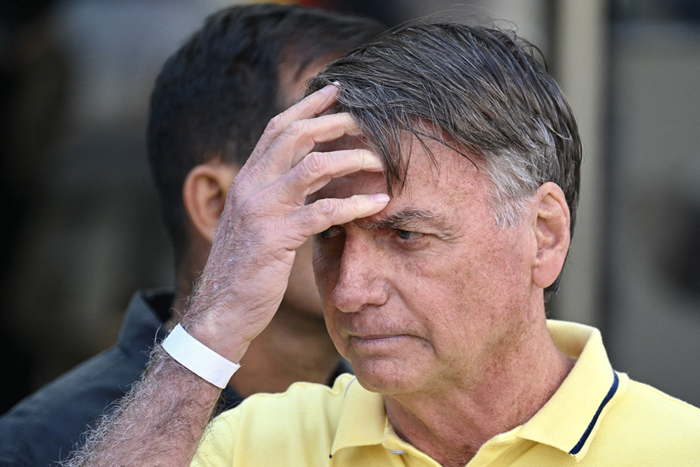 Former Brazilian President Jair Bolsonaro gestures after taking medical tests at DF Star hospital in Brasilia on August 16, 2025.