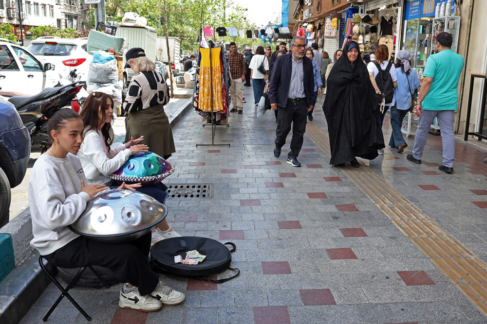 Iranian street musicians perform along a street in Tehran on April 25, 2026. 