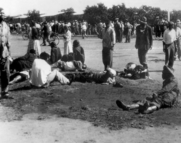 Wounded people lie in the street, 21 March 1960 in Sharpeville, near Vereeniging, where at least 180 black Africans, most of them women and children, were injured and 69 killed, when South African police opened fire on black protestors. The protest was organized by the Pan Africanist Congress (PAC) against pass laws, which required all blacks to carry pass books (identity cards) at all times. On 30 March 1960, the government declared a state of emergency, detaining more than 18,000 people. The Sharpeville massacre led to the banning of the ANC and PAC and signalled the start of armed resistance in South Africa with the foundation of Umkhonto we Sizwe, the military wing of the ANC, and Poqo, the military wing of the PAC. 