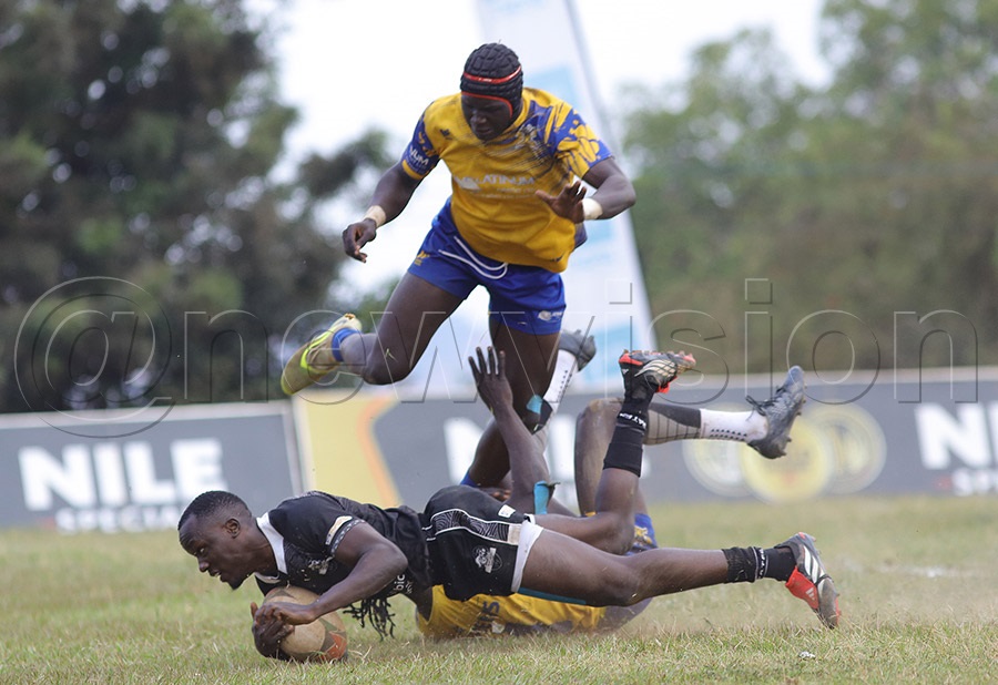 Stanbic Black Pirates' Jones Kamiza scores a try against the Heathens during the Rujumba 7s final at Kings Park Arena, Bweyogerere. PHOTO: Johnson Were