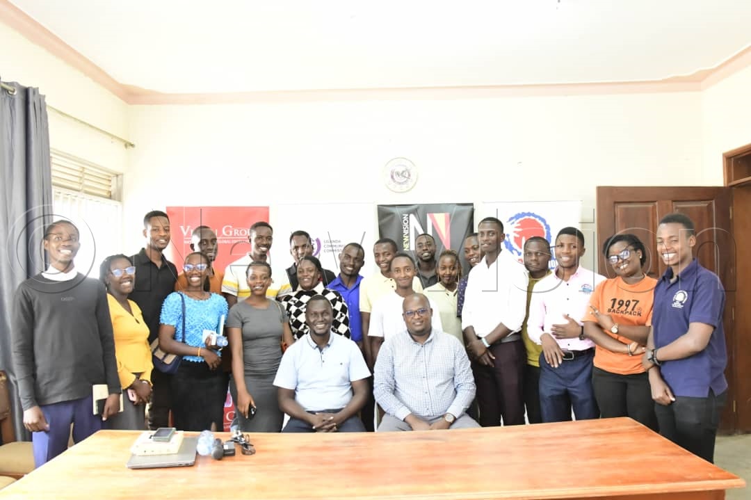 Max Adii and Jude Mulindwa in a group picture with the students of Bishop Stuart University Mbarara. (Credit: Eddie Ssejjoba)