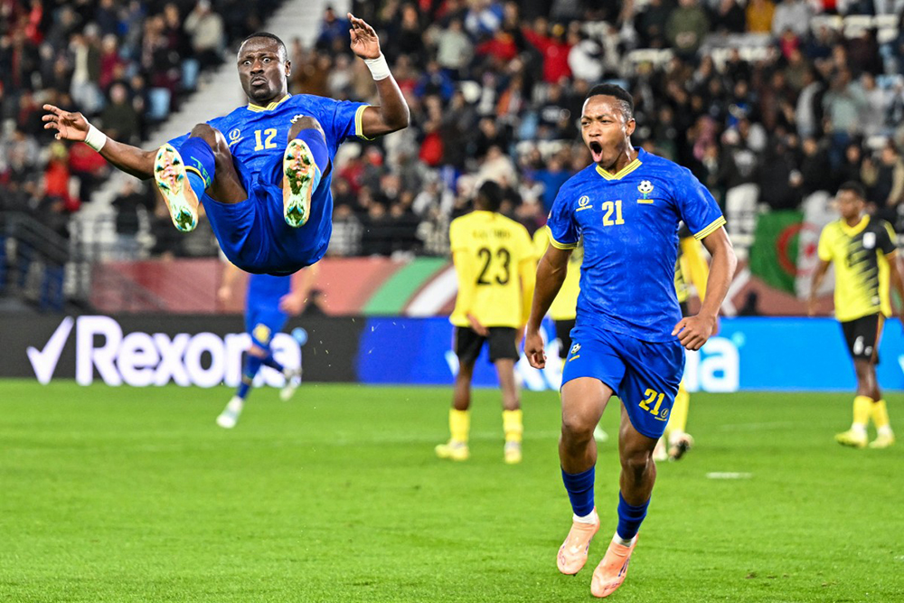 Tanzania's forward #12 Simon Msuva celebrates his goal with Tanzania's forward #21 Kelvin John during the Africa Cup of Nations (CAN) Group C football match between Uganda and Tanzania at Al Medina Stadium in Rabat on December 27, 2025. (Photo by SEBASTIEN BOZON / AFP)