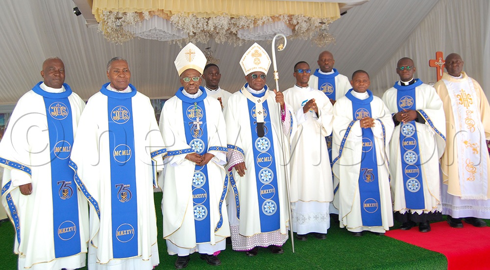 Archbishop Paul Ssemogerere (holding a crosier) shares a photo moment with Archbishop Dr Augustine Kasuujja (third-left) and other clerics after Mass. (Photo by Mathias Mazinga)