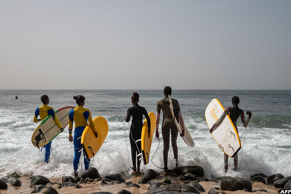Young participants of the Surf Academy programme prepare to set off for a two-hour training session at sea