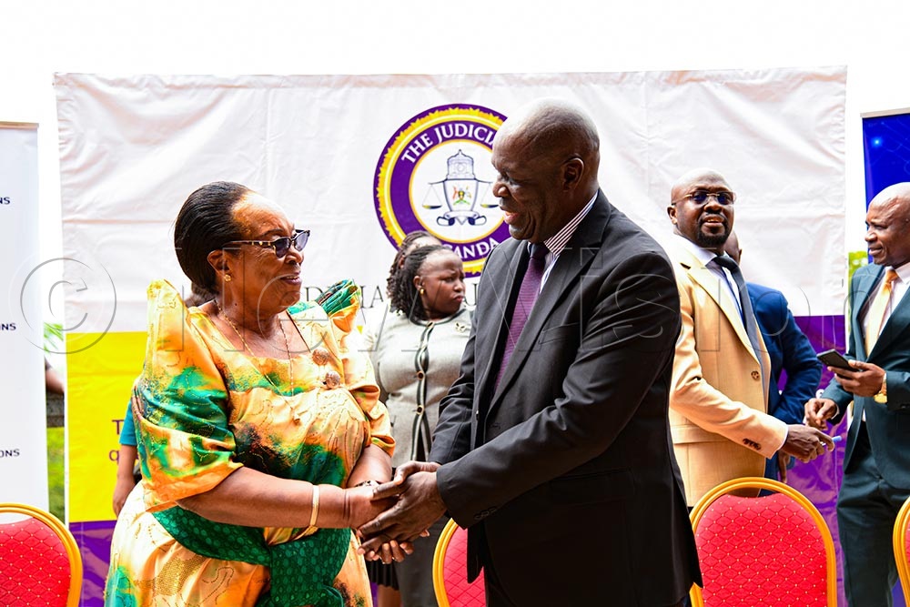 ICT State Minister Joyce Nabbosa Ssebugwawo greets Deputy Chief Justice Moses Kazibwe Kawumi upon her arrival at Serena, Kigo. (Credit: Farooq Kasule)