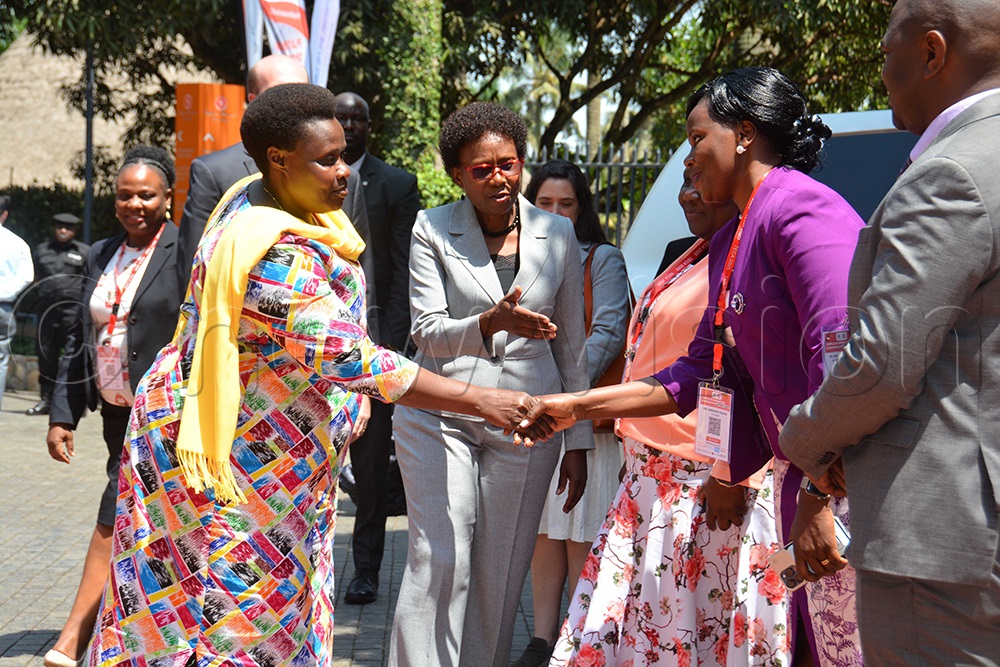 The Vice President Jessica Alupo ( left) interacts with Dr Suzan Nabadda as she is being introduced by the Health minister Dr Ruth Acheng. (Photo by Francis Emorut)