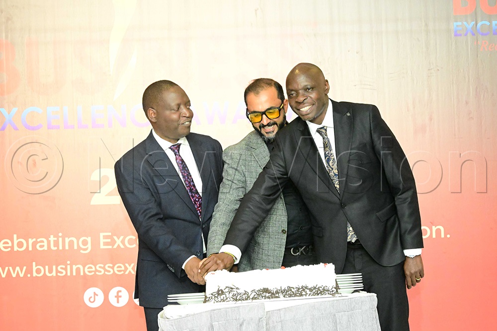 Ministers David Bahati (left) and Alioni Yorke Odria for National Guidance join Paresh Mehta, chairman of the Indian Association of Uganda, to cut a cake after the awards ceremony. (Photo by Eddie Ssejjoba)