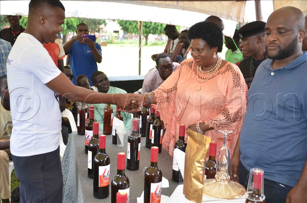 Minister Amongi being welcomed Okwir Okwir the director of Hava wine in his stall during the expo at Mayor`s Garden in Lira City.