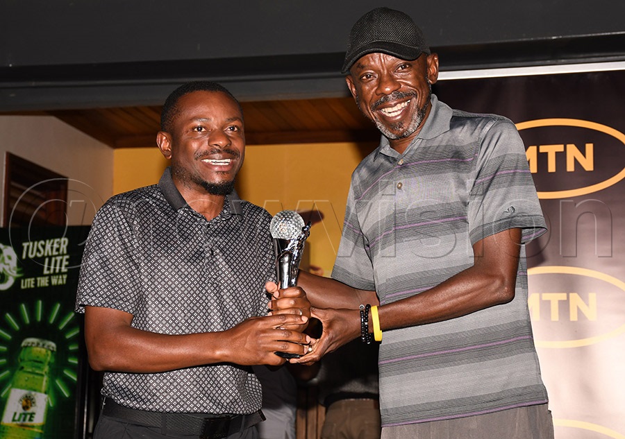 Mathias Mulumba Zungu  (left) receives her trophy from MTN's Michael Sekadde after the MTN Monthly Tees tournament for the month of march at Entebbe Club, March 21, 2026. He returned as Group B winner in April. Photo by Michael Nsubuga
