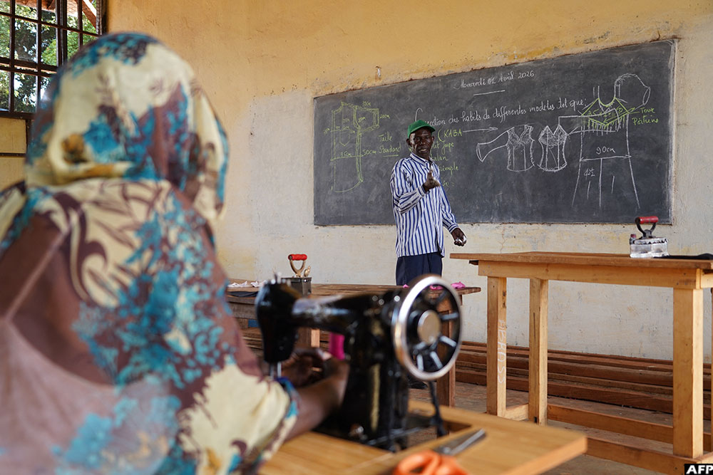 Christophe Yonaba, a sewing instructor, teaches his students, all of them former child soldiers, at the Bria Practical Vocational Training and Literacy Centre in Bria